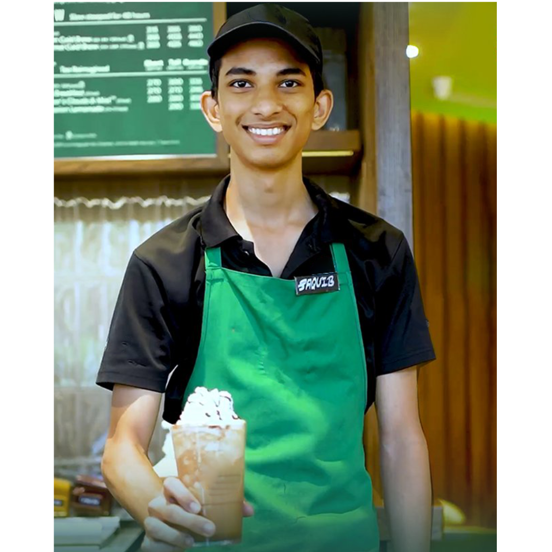 Barista in a green Starbucks apron, without a logo